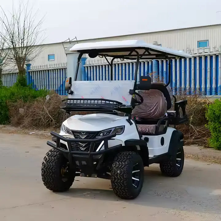 White off-road golf cart with a canopy on a paved surface, with a building and trees in the background.