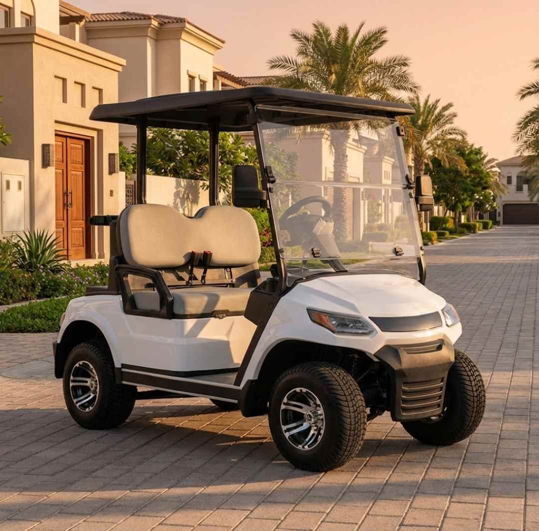 White golf cart on a paved driveway with a residential background