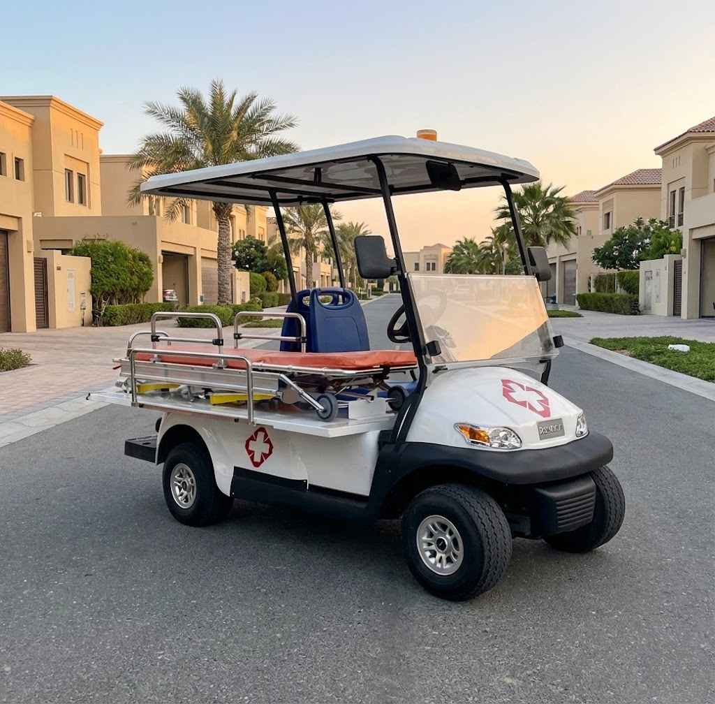 White golf cart with emergency medical equipment on a paved road.