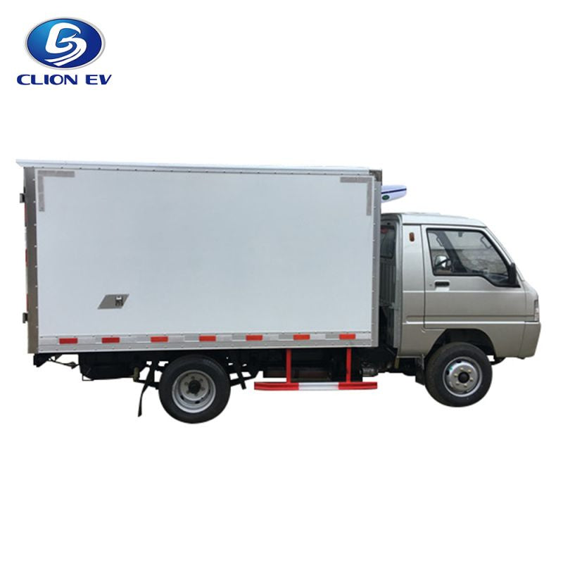 UAE golf cartz side profile studio shot of a silver electric refrigerated truck with a large, white insulated cargo box, set against a pure white background. This specialized electric commercial vehicle is a refrigerator delivery van designed for transporting temperature-sensitive goods, featuring a driver's cab and a side reflective safety strip along the bottom of the box.