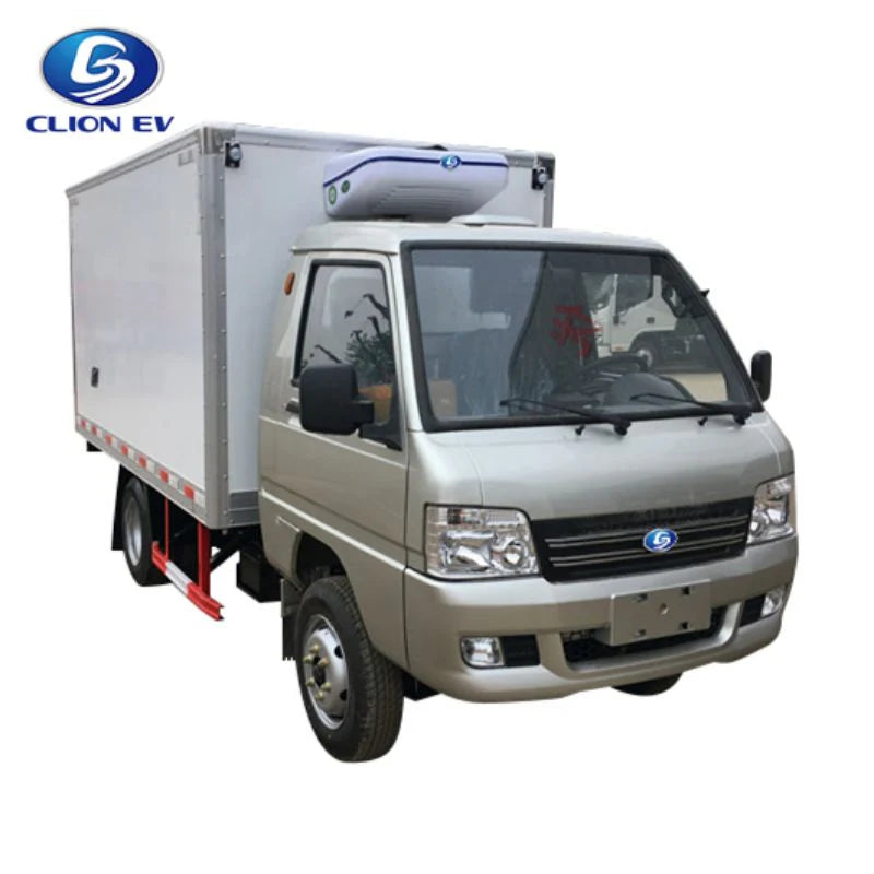 UAE golf cartz three-quarter front studio shot of a silver electric refrigerated truck with a large, white insulated cargo box, set against a white background. This specialized electric commercial vehicle is a heavy-duty refrigerator delivery van for cold chain logistics, featuring a cab-over-engine design and a white and blue refrigeration unit mounted on the box roof.