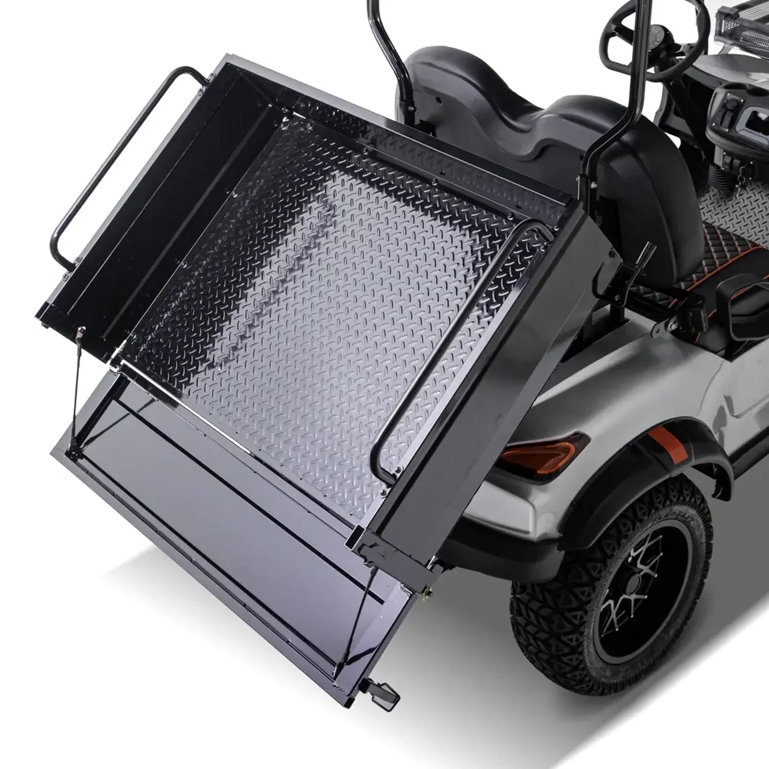 UAE golf cartz close-up rear view of a silver utility golf cart demonstrating its rear dump bed or tilting mechanism. The black metal cargo box, which features a diamond-plate floor, is partially raised. The image highlights the heavy-duty function of the electric work cart, including the black fender flare, all-terrain tire, and custom wheel, set against a white background.