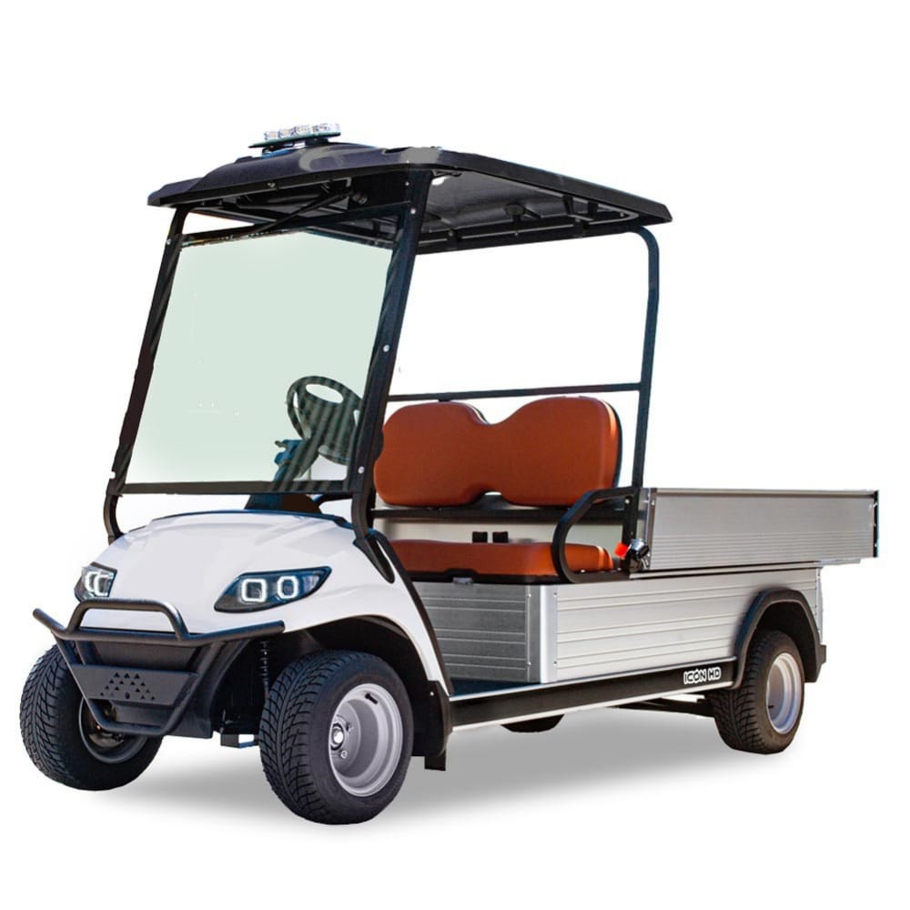 UAE golf cartz three-quarter front studio shot of a white utility electric vehicle with a flat, silver aluminum cargo bed, set against a pure white background. This specialized electric work cart features a black roof, a black front brush guard, and brown two-seater upholstery. The utility golf cart has a wide windshield, all-terrain tires, and silver wheels, emphasizing its heavy-duty hauling capabilities.