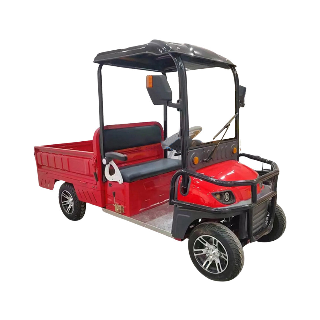 UAE golf cartz three-quarter front studio shot of a red utility electric vehicle with a short flatbed, set against a pure white background. This two-seater electric work cart features a black roof, black seats, a robust black front brush guard, and a small windshield with a wiper. The electric utility truck has custom silver alloy wheels and is designed for commercial hauling and property maintenance tasks.