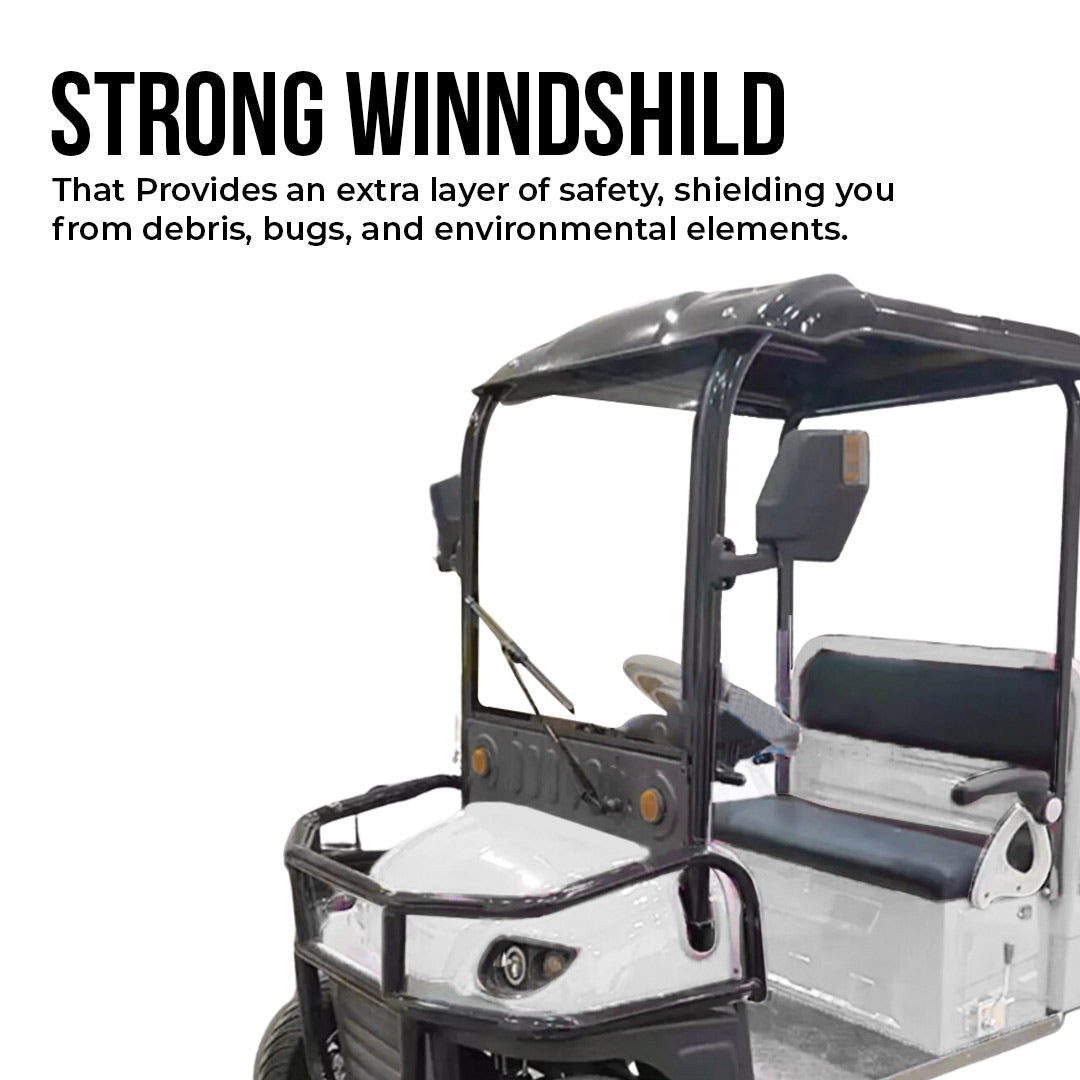 UAE golf cartz promotional image highlighting the strong windshield of a white utility electric vehicle with a flatbed. The shot shows the driver area with a black roof, front brush guard, and black seats. Text on the image emphasizes the windshield as an extra layer of safety, shielding from debris, bugs, and environmental elements, promoting this key safety feature of the work cart.