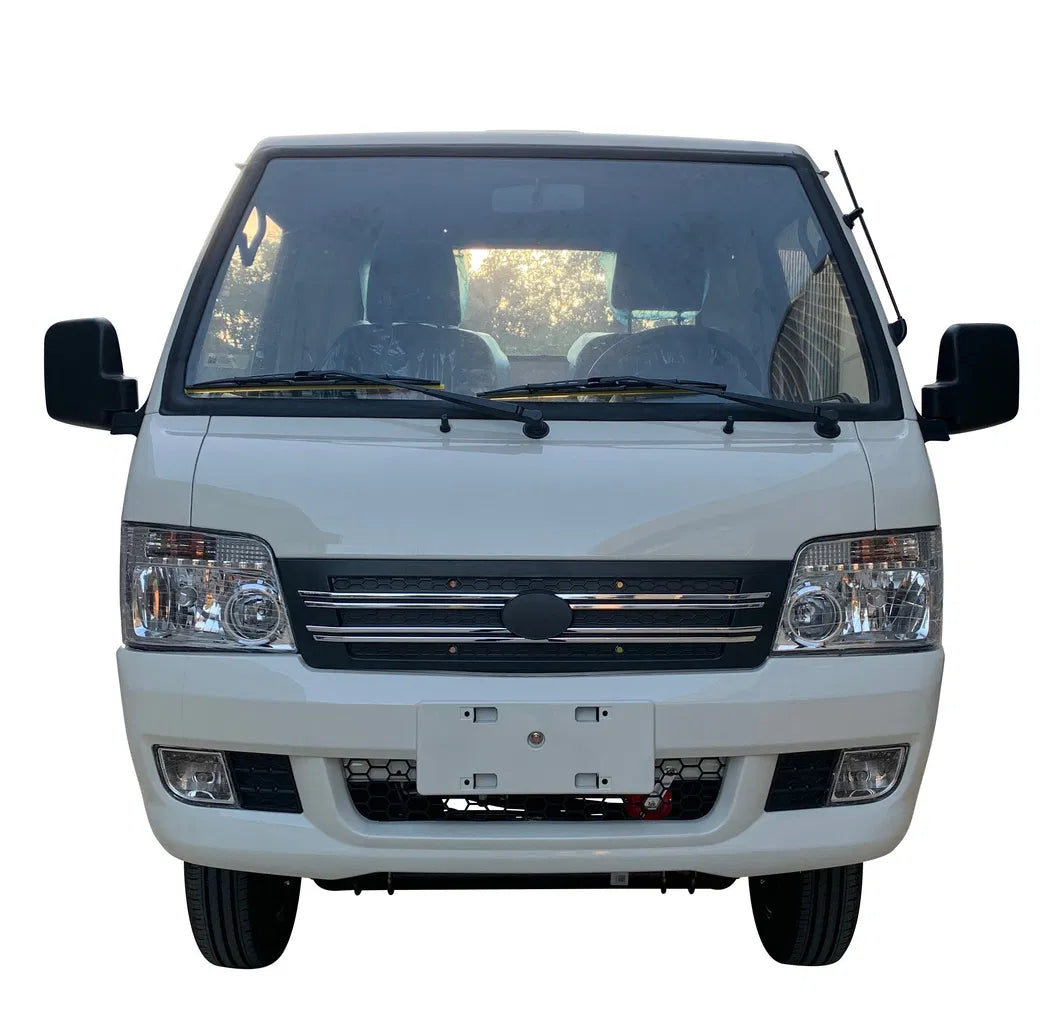UAE golf cartz head-on studio shot of a white electric flatbed truck or mini truck with a single cab, set against a white background. This electric commercial utility vehicle features a large windshield, twin headlights, a black grille, and fog lights on the front bumper. The image highlights the professional, road-ready front design of the electric work truck.