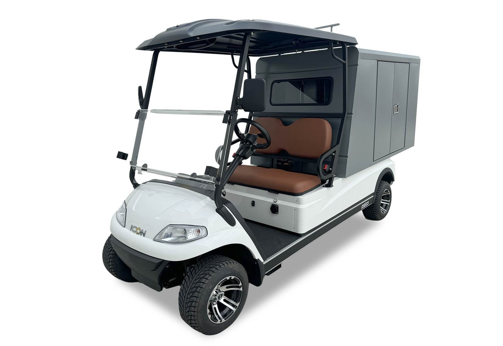 UAE golf cartz three-quarter front studio shot of a white two-seater utility golf cart with a black roof, set against a pure white background. This specialized electric work cart features a large, enclosed grey rear storage cabinet with black doors and a small window, designed for secure maintenance and delivery tasks. The cab area has brown seats and a folding windshield. The electric service vehicle is equipped with all-terrain tires and custom black and chrome wheels.