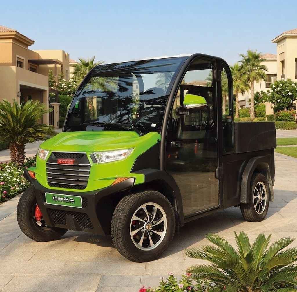 Green utility vehicle on a paved area with palm trees and buildings in the background