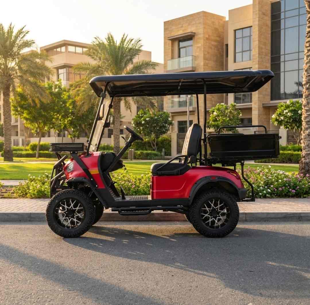 Red golf cart on a paved road with buildings and palm trees in the background