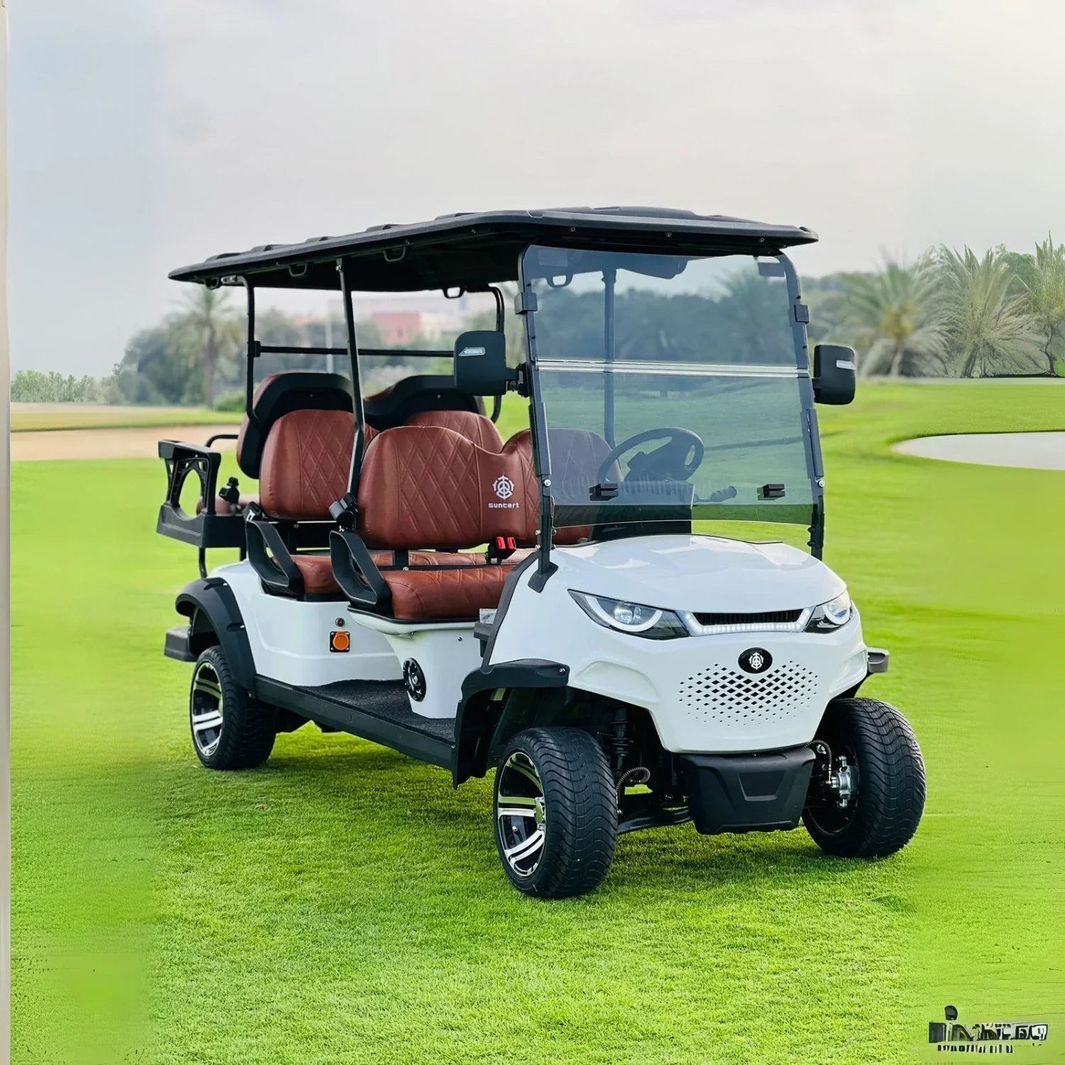 White golf cart with brown seats on a golf course