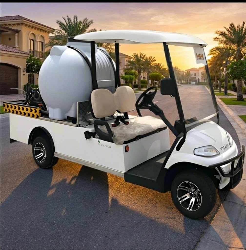 White golf cart with large white tank on a road during sunset.